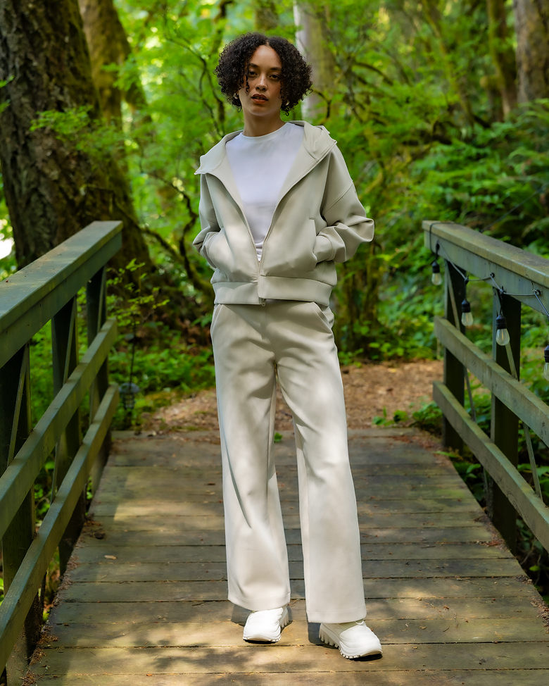 A man wearing a white sweat set outside