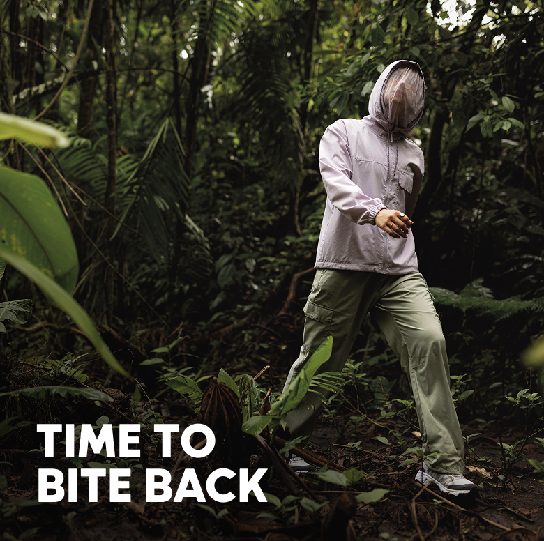 A woman walking in a lush jungle with text: TIME TO BITE BACK