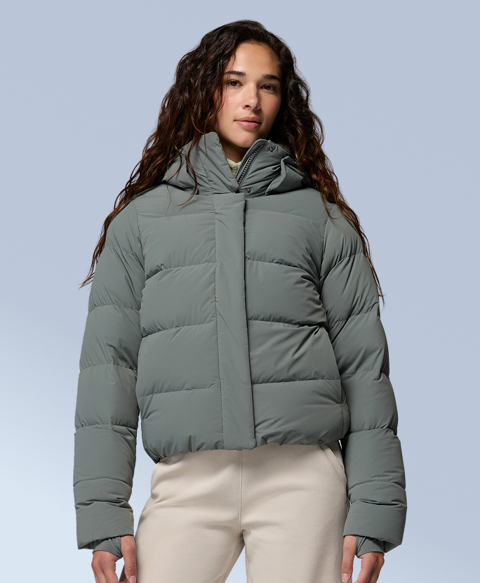 A woman wearing a green puffer jacket.