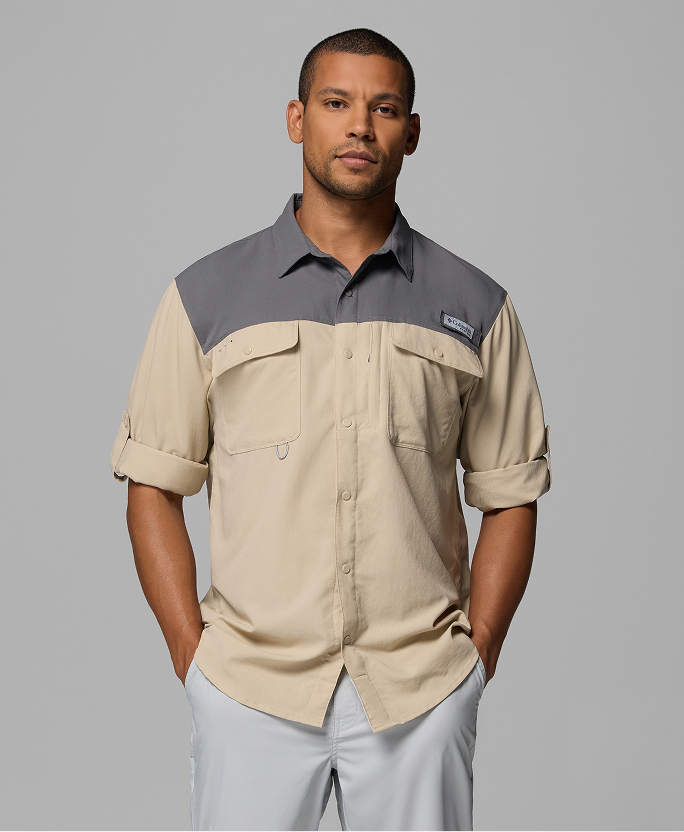 A man wearing a short sleeve tan button-up shirt.