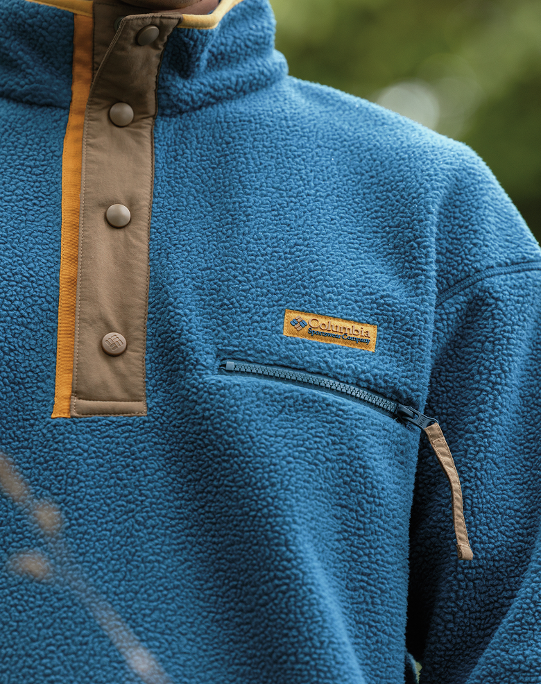 Close-up of a blue fleece pullover with the Columbia logo on the front.