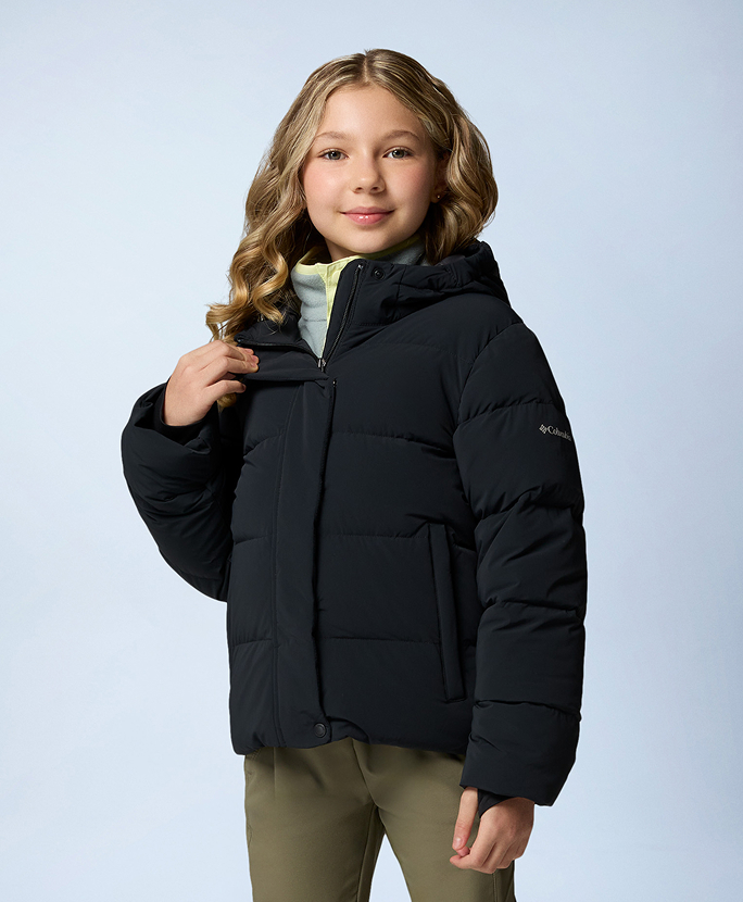 A little girl wearing a black puffer jacket.