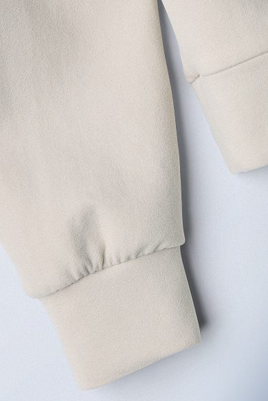 close up of white hoodie on grey background