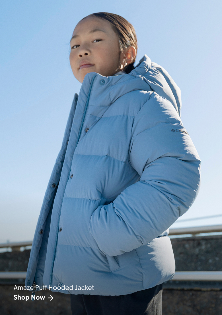A girl wearing a light blue hoodie against a blue sky with text: Amaze Puff Hooded Jacket Shop Now
