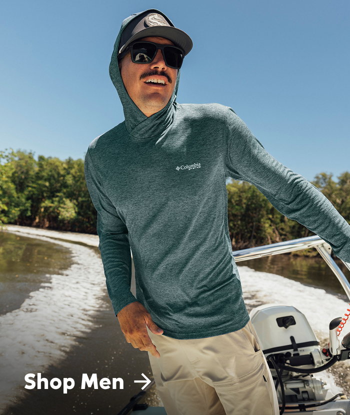 Shop Men. A close up of a man driving his boat. 