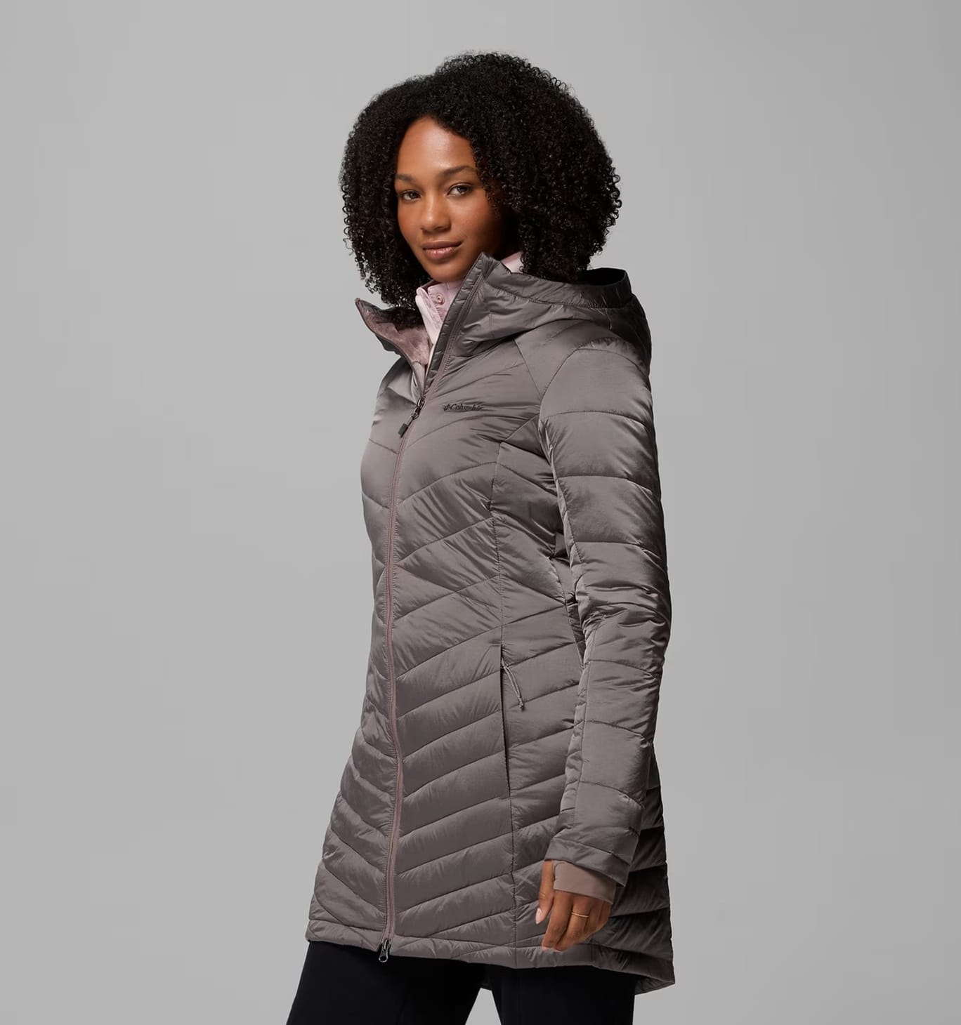 A woman wearing a gray puffer jacket.