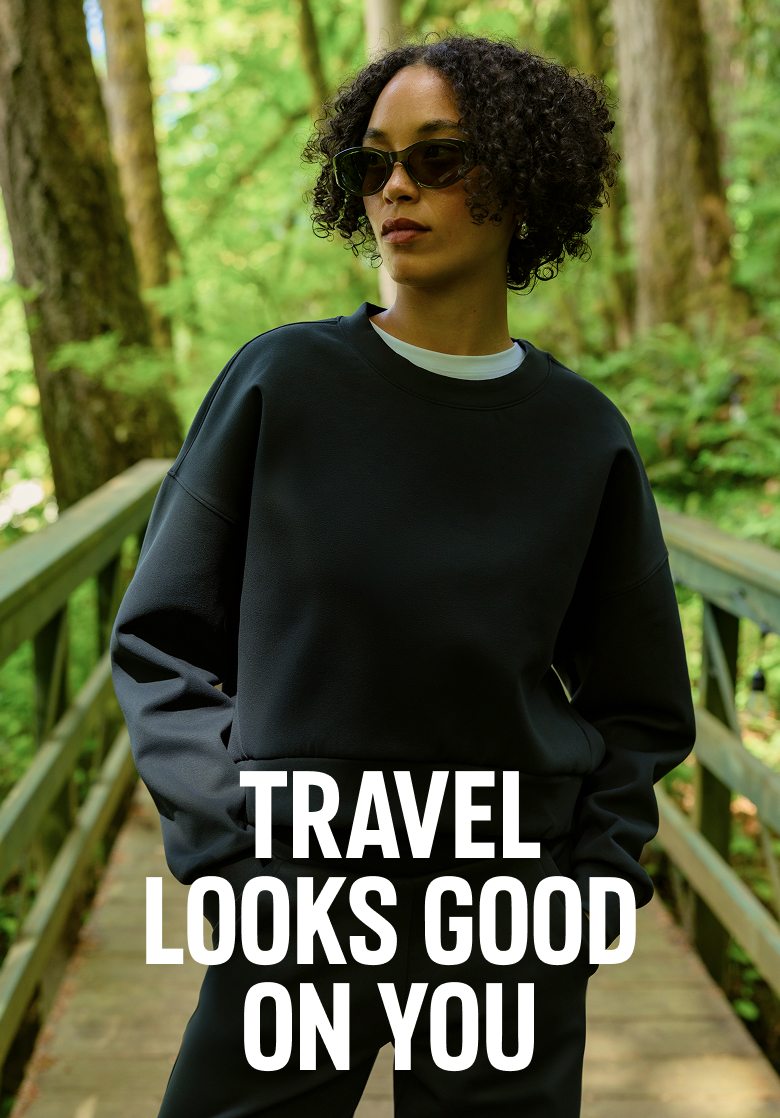A woman model in a black sweat set with Travel Looks Good on You