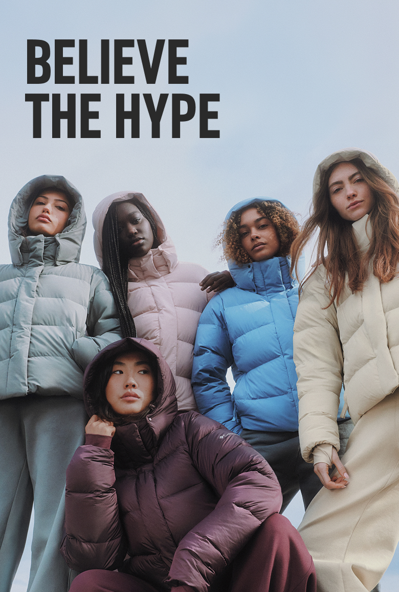A group of women wearing colorful puffer jackets with text: BELIEVE THE HYPE