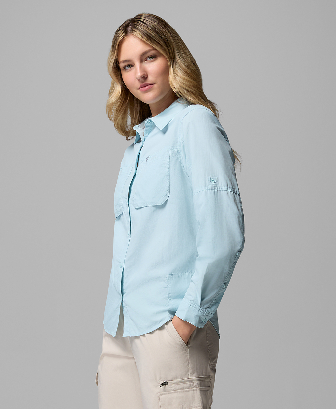A woman wearing a blue long sleeve button-up shirt.