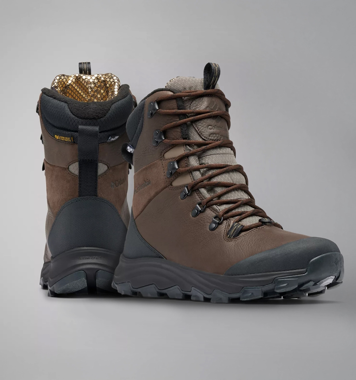 Two brown snow boots with a gold interior.